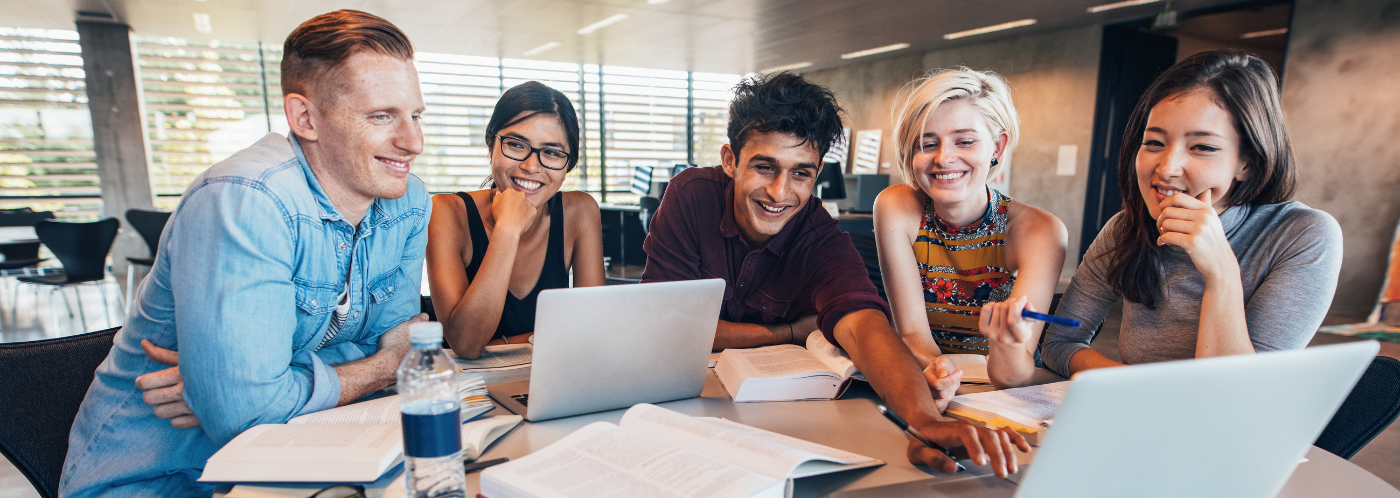 People sitting around a computer and laughing